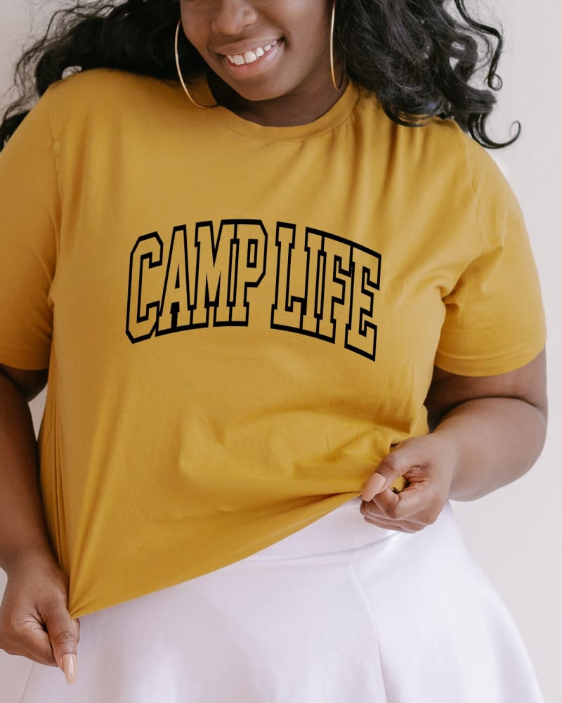 Front of a model wearing a size 2XL Camp Life Varsity in Mustard by Simply Sage Market. | dia_product_style_image_id:281482